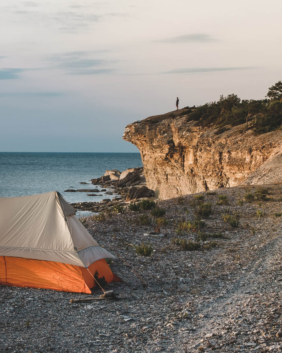 Kustklippa vid havet med tält och utsikt över havslandskap